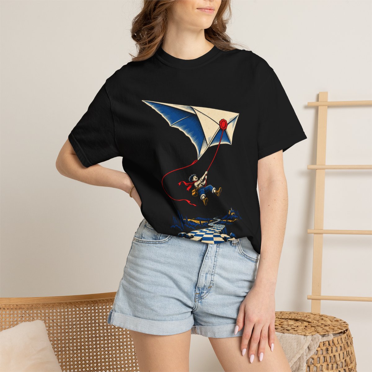Letter Kite Tee worn Printify context view on a Black Comfort Colors 1717 tee